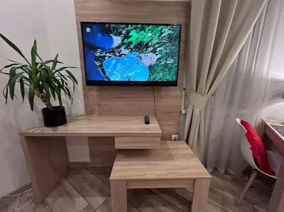 a living room with a tv and a wooden table at Old Town Apartments - B5 in Kraków