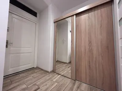 a room with a sliding door and a hallway at Old Town Apartments - B5 in Kraków