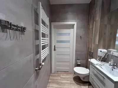 a bathroom with a toilet and a sink at Old Town Apartments - B5 in Kraków