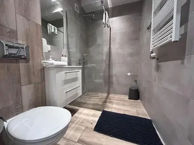 a bathroom with a toilet and a sink and a shower at Old Town Apartments - B5 in Kraków