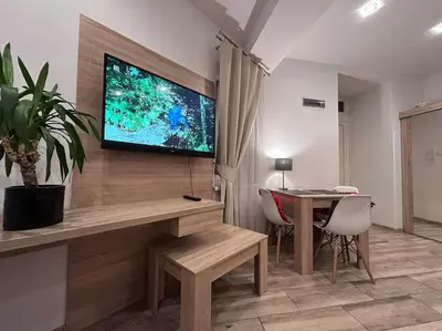 a living room with a flat screen tv on a wall at Old Town Apartments - B5 in Kraków