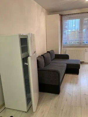 a living room with a couch and a refrigerator at Studio in Krakow in Kraków