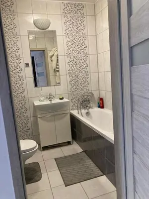 a bathroom with a sink and a tub and a toilet at Studio in Krakow in Kraków
