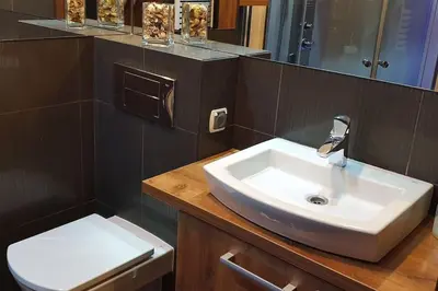 a bathroom with a sink and a toilet at Apartament z sauną i jacuzzi in Kraków