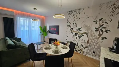 a living room with a table and a couch at Bagry Luxury Apartment 19 in Kraków