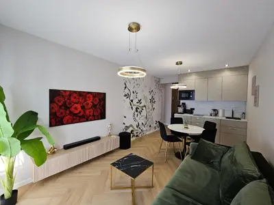 a living room with a couch and a table at Bagry Luxury Apartment 19 in Kraków