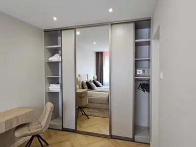 a room with sliding glass doors leading to a bedroom at Bagry Luxury Apartment 19 in Kraków