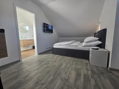 a bedroom with a bed and a large mirror at Apart Bogi in Szczyglice