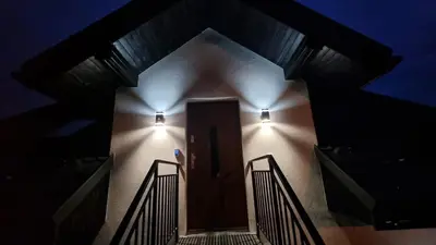 a stairway with two lights on the side of a building at Apart Bogi in Szczyglice