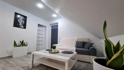 a living room with a couch and a table at Apart Bogi in Szczyglice