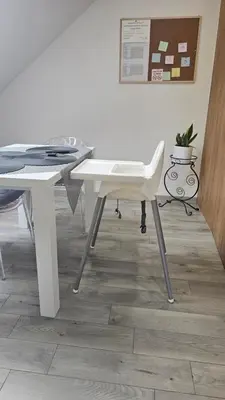 a white desk and a chair in a room at Apart Bogi in Szczyglice