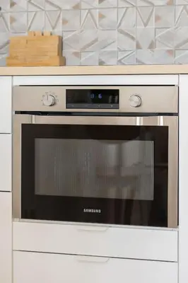 a stainless steel oven in a kitchen at Modern Apartment with Parking near Tauron Arena Kraków by Noclegi Renters in Kraków