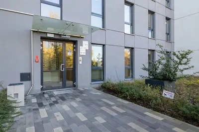 an entrance to a building with a glass door at Modern Apartment with Parking near Tauron Arena Kraków by Noclegi Renters in Kraków