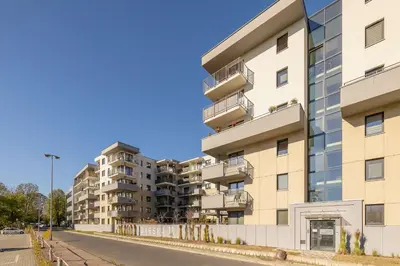 an apartment building on the side of a street at Modern Apartment with Parking near Tauron Arena Kraków by Noclegi Renters in Kraków
