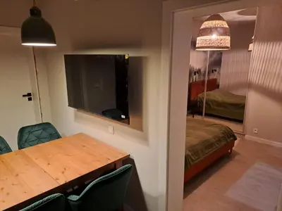 a room with a table and a bed and a mirror at Leśna24 in Rabka-Zdroj