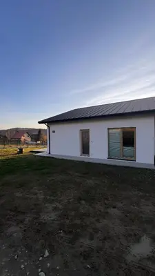 a white building with a yard in front of it at Leśna24 in Rabka-Zdroj