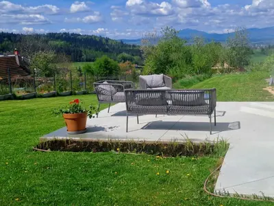 two benches sitting on a patio in the grass at Leśna24 in Rabka-Zdroj