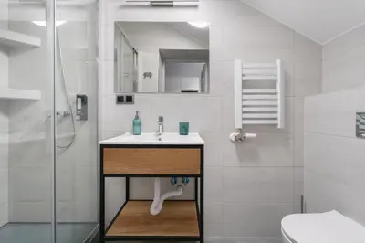 a bathroom with a sink and a shower at DOLCE VITA Elegant Apartments in Kraków