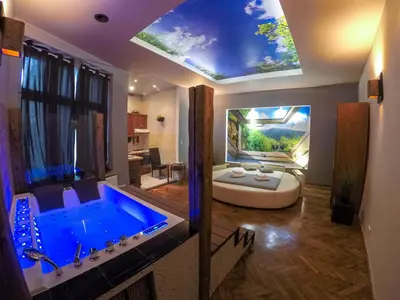 a bathroom with a large blue tub in a room at Apartament z jacuzzi Kraków Rynek in Kraków