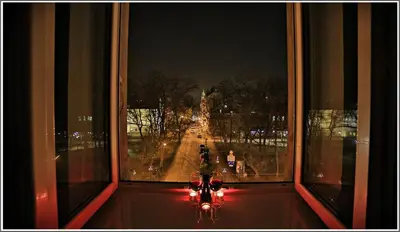 a window with a view of a street at night at Apartament z jacuzzi Kraków Rynek in Kraków