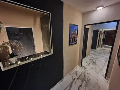 a bathroom with a large mirror and a hallway at Apartament z jacuzzi Kraków Rynek in Kraków