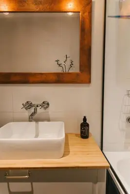 a bathroom with a white sink and a shower at Stylowy Apartament Eden-Arena in Kraków