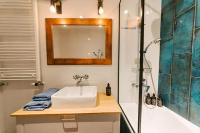 a bathroom with a sink and a shower at Stylowy Apartament Eden-Arena in Kraków