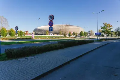 an empty street with a building in the background at Stylowy Apartament Eden-Arena in Kraków