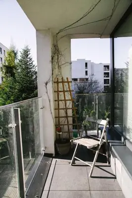 a chair sitting on top of a balcony at Stylowy Apartament Eden-Arena in Kraków