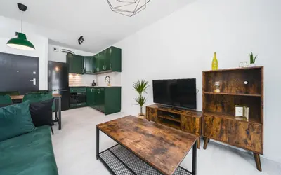 a living room with a couch and a wooden table at Wielicka in Kraków