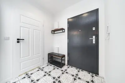 a room with a black door and a tiled floor at Wielicka in Kraków