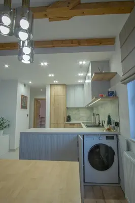 a kitchen with a washing machine in a kitchen at Apartament Mikołaja w Rabce in Rabka