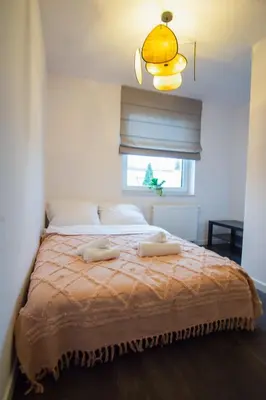 a bedroom with a bed with two towels on it at Apartament Mikołaja w Rabce in Rabka