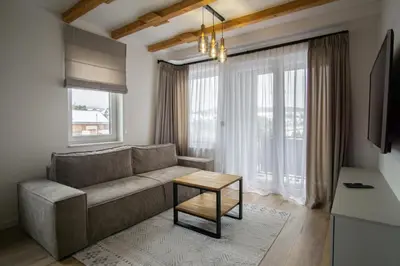 a living room with a couch and a table at Apartament Mikołaja w Rabce in Rabka