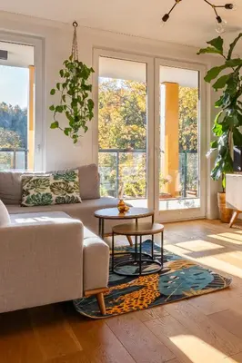 a living room with a couch and a table at GREEN OASIS - free parking, big balcony, private park in Kraków