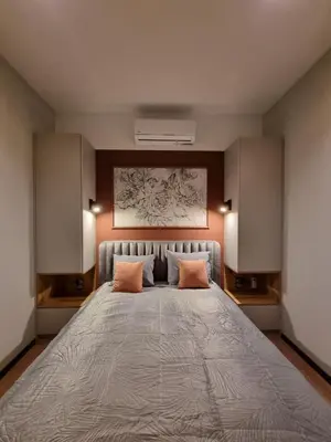 a bedroom with a large bed with two orange pillows at Apartment in the heart of Old Podgórze in Kraków