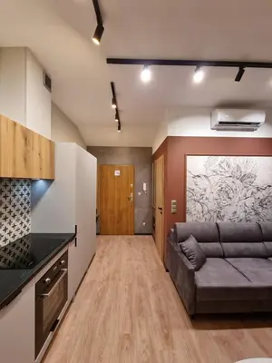 a living room with a couch and a kitchen at Apartment in the heart of Old Podgórze in Kraków