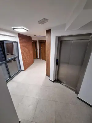 an empty hallway with two garage doors and a brick wall at Apartment in the heart of Old Podgórze in Kraków