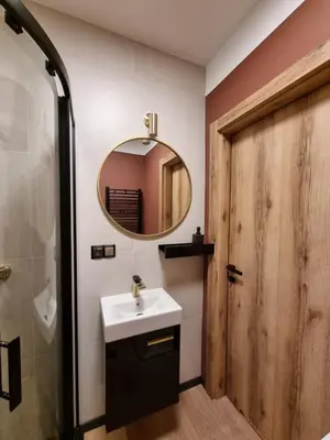 a bathroom with a sink and a mirror at Apartment in the heart of Old Podgórze in Kraków