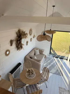a living room with a table and a couch at Domek na Odludziu - Tiny House in Spytkowice