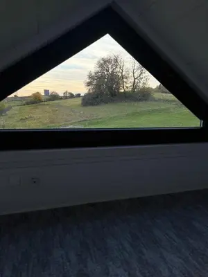 a window in a room with a view of a field at Domek na Odludziu - Tiny House in Spytkowice