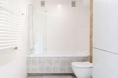 a white bathroom with a toilet and a shower at Native Apartments Barska 13 in Kraków