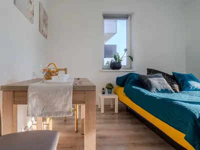 a bedroom with a bed and a dining table at Miły Pobyt w mieście in Kraków