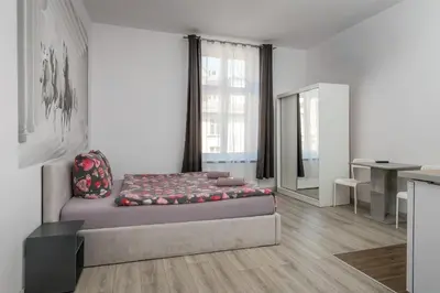 a kitchen with a desk and a table in a room at 70s Business Room in Kraków