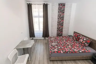 a living room with a bed and a table at 70s Business Room in Kraków