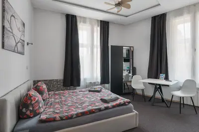 a small room with two beds and a kitchen at 70s Business Room in Kraków