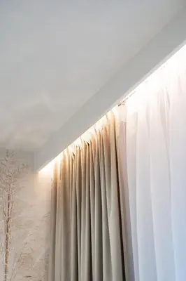 a window with a white curtain in a room at Luxury Apartments in Kraków