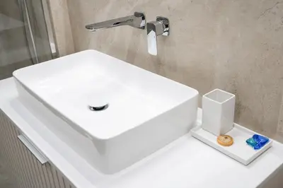 a white sink sitting on a counter in a bathroom at Luxury Apartments in Kraków