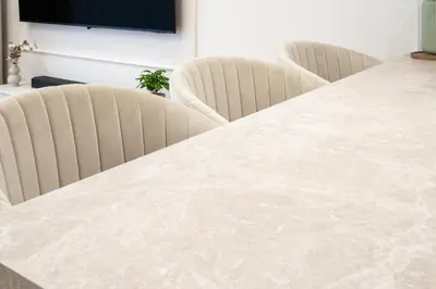 a white marble table with two chairs behind it at Luxury Apartments in Kraków