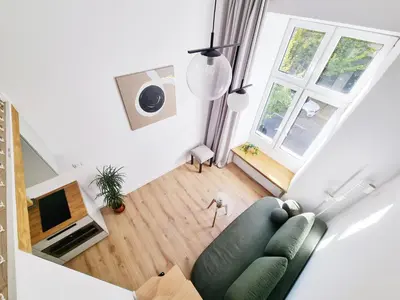 an overhead view of a living room with a green couch at Nad Szklarnią in Kraków